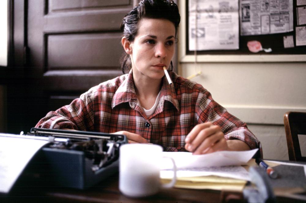 Lili Taylor at a desk in I Shot Andy Warhol