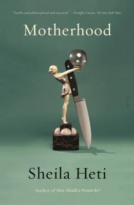 the cover of motherhood shows a statuette of a woman holding up a crystal ball with a knife leaning against her