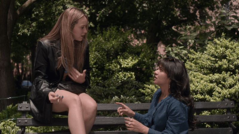 Saint X: Alycia Debnam-Carey as Emily talking to her best friend Sunita on a bench