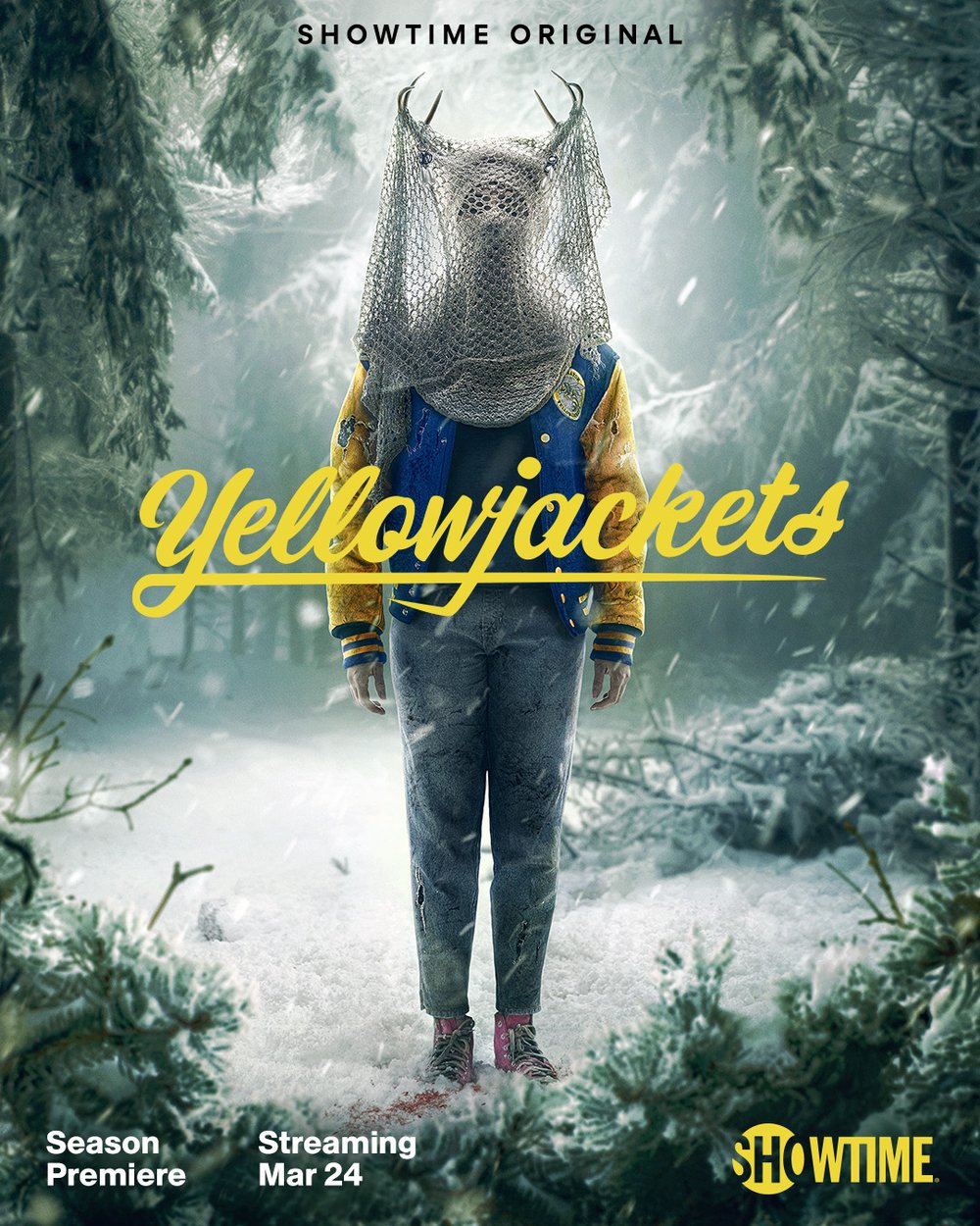 the cover of yellowjackets shows the antler queen in jeans and a letterman jacket in the wintery woods