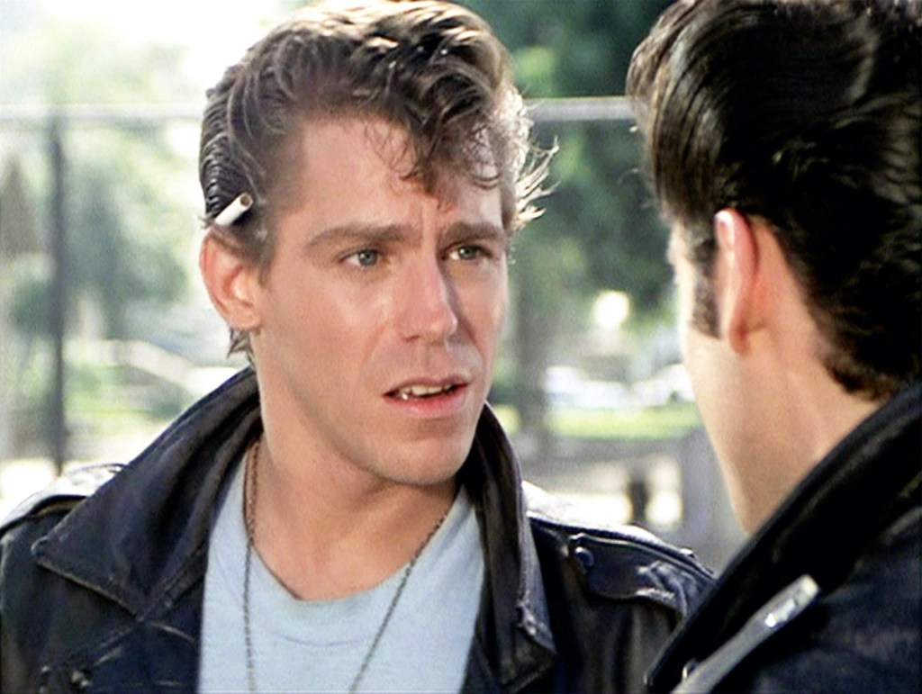 Kenicke in a leather jacket with gelled hair and a cig behind his ear in "Grease"