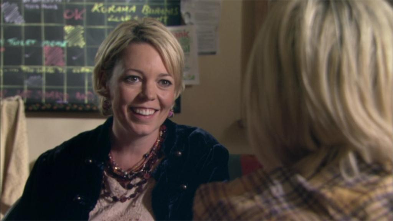 Gina smiles at Naomi across the table on Skins