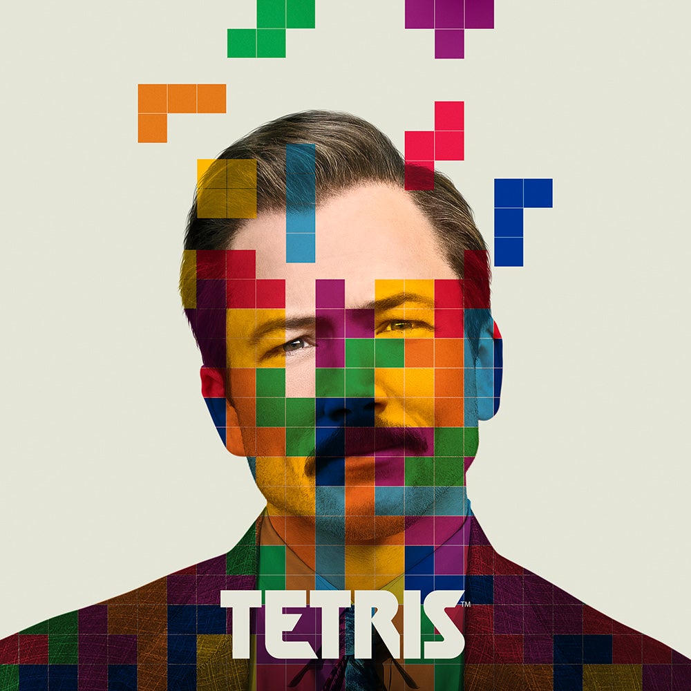 the cover of tetris shows a man with a mustache with tetris shapes over him