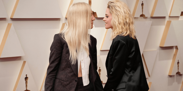 Dylan Meyer and Kristen Stewart leaning toward each other on the Oscars red carpet