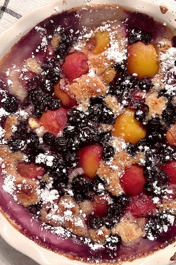 A close up of peach blueberry cobbler