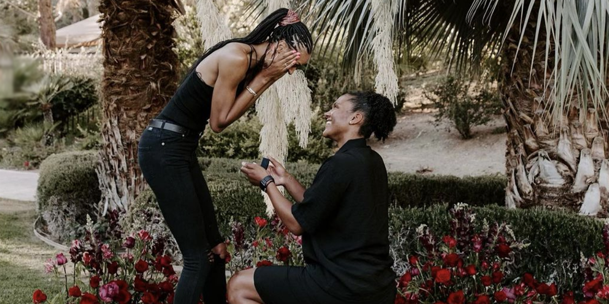 Down on one knee, Alyssa Thomas holds a ring out to a shocked DeWanna Bonner.