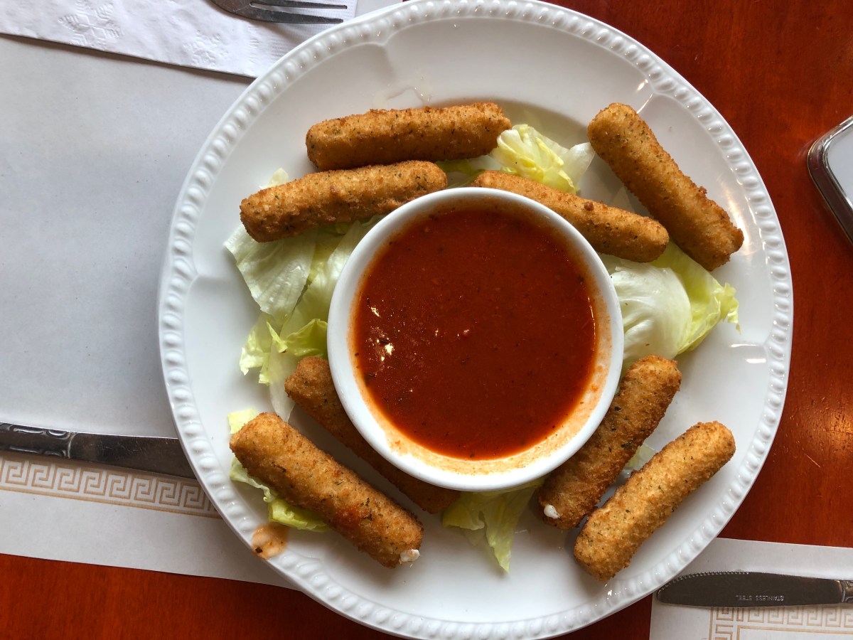 mozarella sticks and marinara in a small bowl