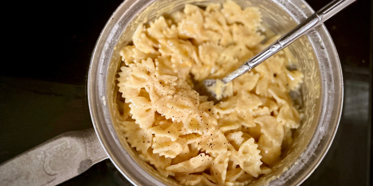 A close up of a photo of easy stovetop macaroni and cheese, made in 20 minutes, with bowtie pasta