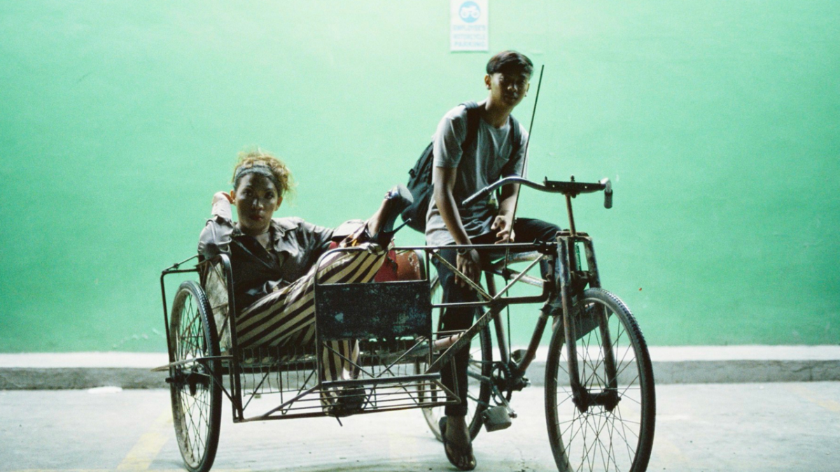 A Filipino taxi bike with a trans woman in back