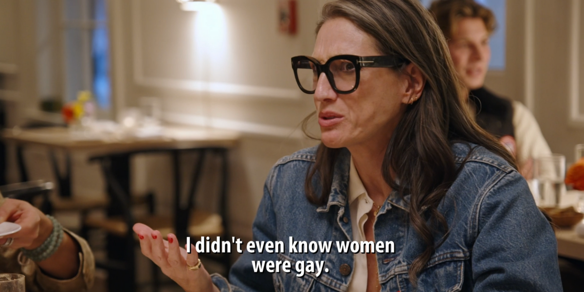 Jenna Lyons in a jean jacket and thick framed glasses saying