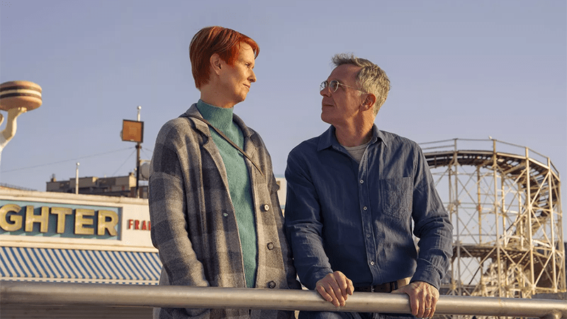 Steve and Miranda stand together on the pier on Coney Island