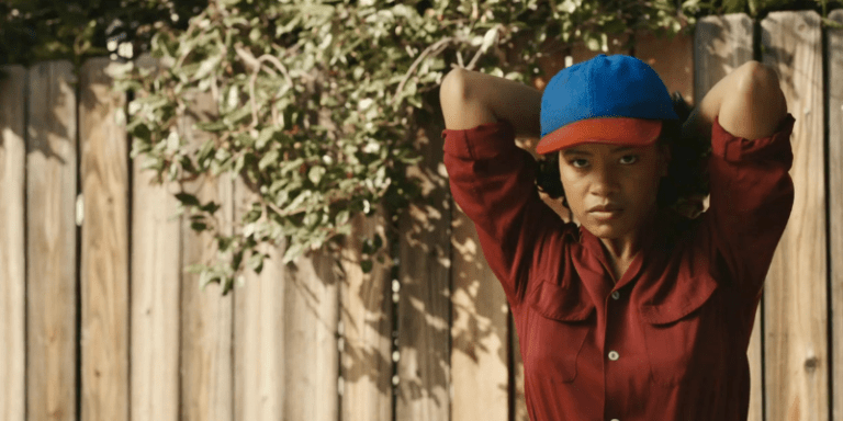 Max Chapman from A League of Their Own prepares to throw a baseball.