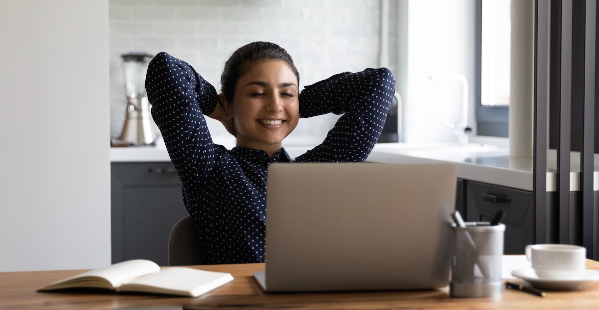 girl happily looking at her laptop