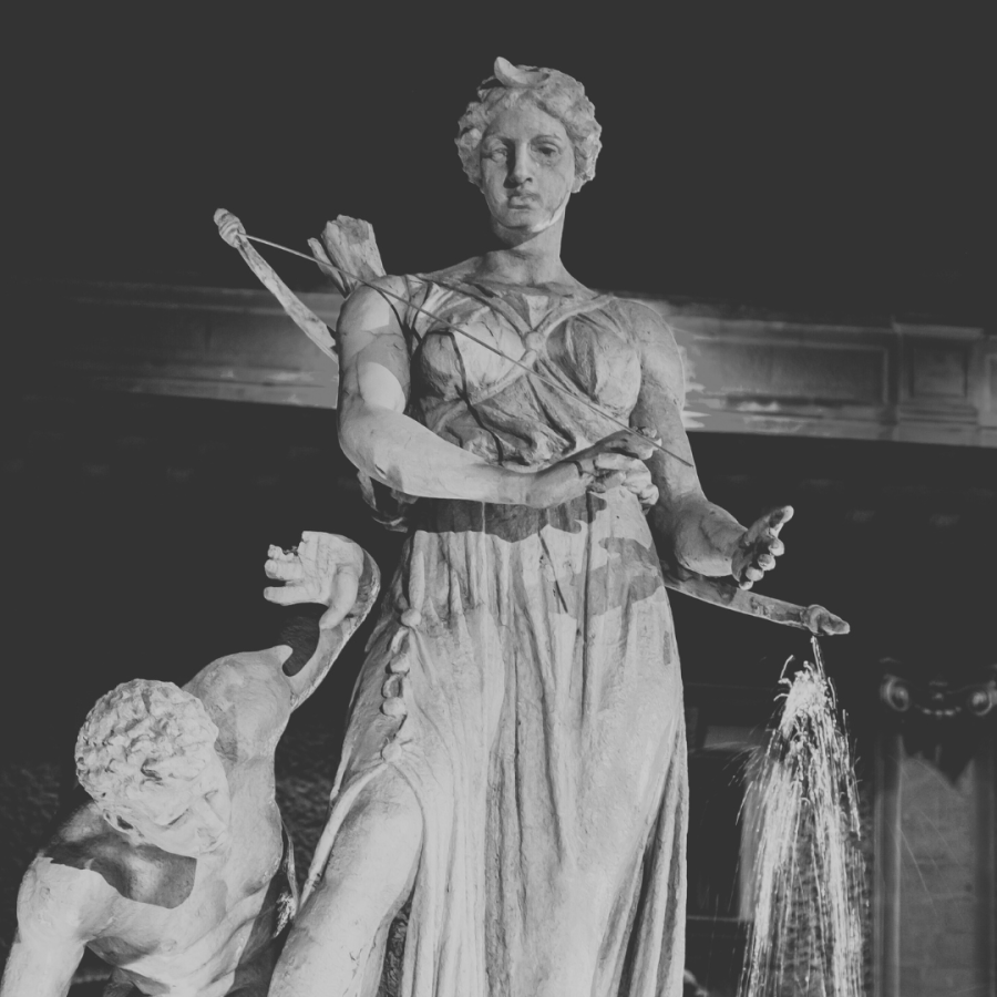 a black and white photo of a statue of artemis, complete with her signature bow and arrow