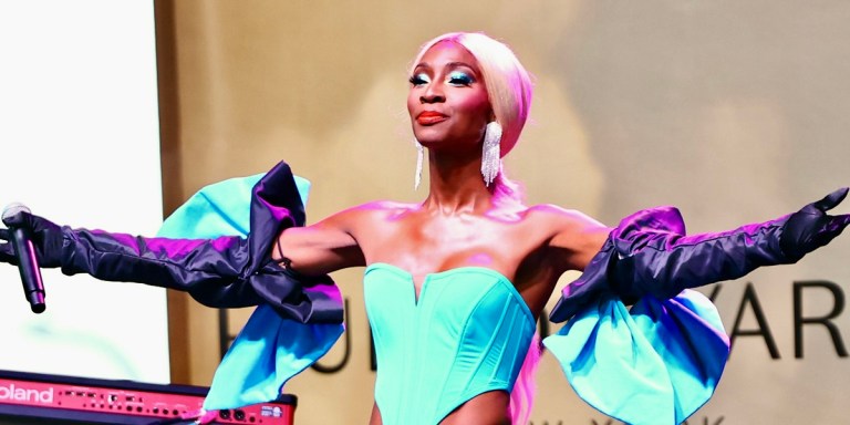 Actress Angelica Ross, who has announced that she's leaving Hollywood, on stage in a turquoise dress looking absolutely regal.