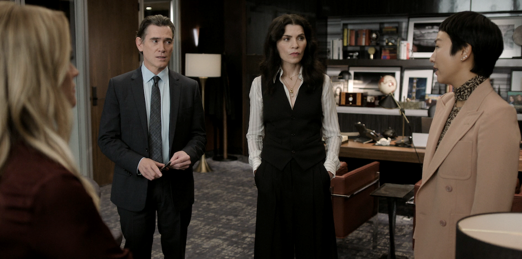 Reese Witherspoon, Billy Crudup, Julianna Margulies, and Greta Lee standing in a board room on The Morning Show