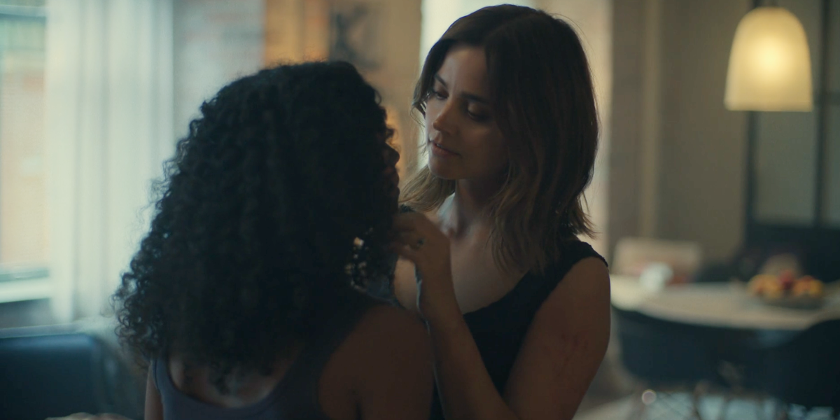 Jenna Coleman as Liv reaches out and gently touches lesbian Ash's face as if about to kiss her