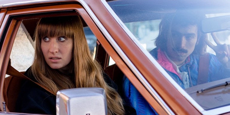 girl in a car lookoing upset with bangs