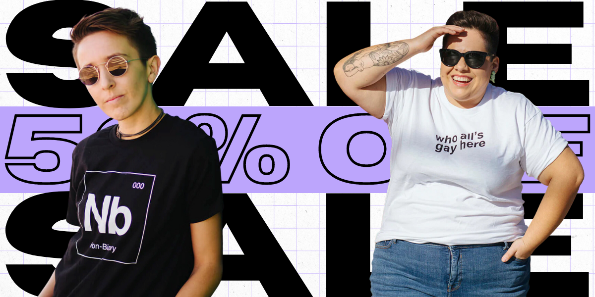 two people model autostraddle tee shirts. one of the models is wearing a nonbinary shirt that says