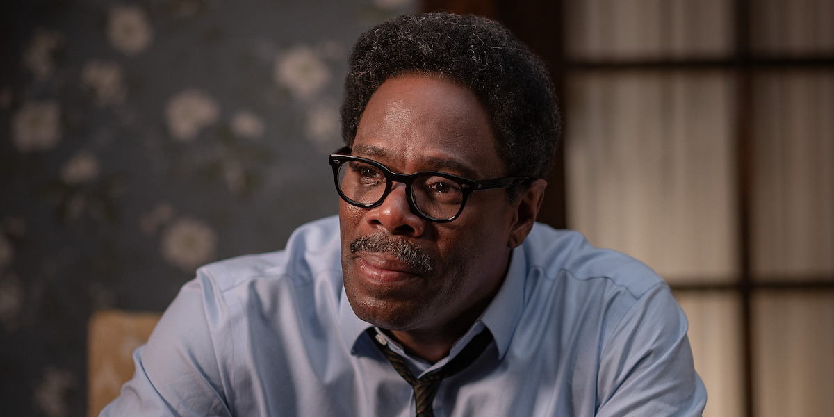 A close up of Colman Domingo as Bayard Rustin in a light blue button down shirt and a skinny brown tie