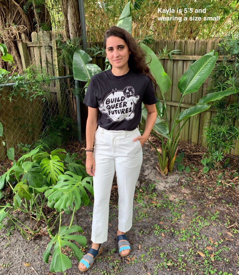 Kayla in a black "Build Queer Futures" t-shirt