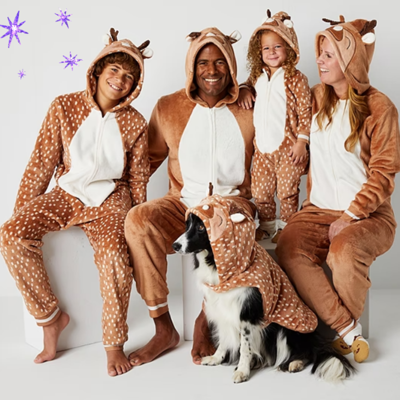 a dog, two kids, and two parents in matching reindeer pajama sets