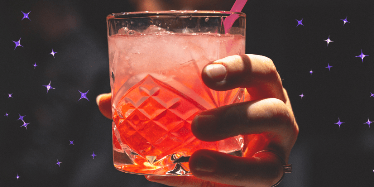 a bartender handing a cocktail to you