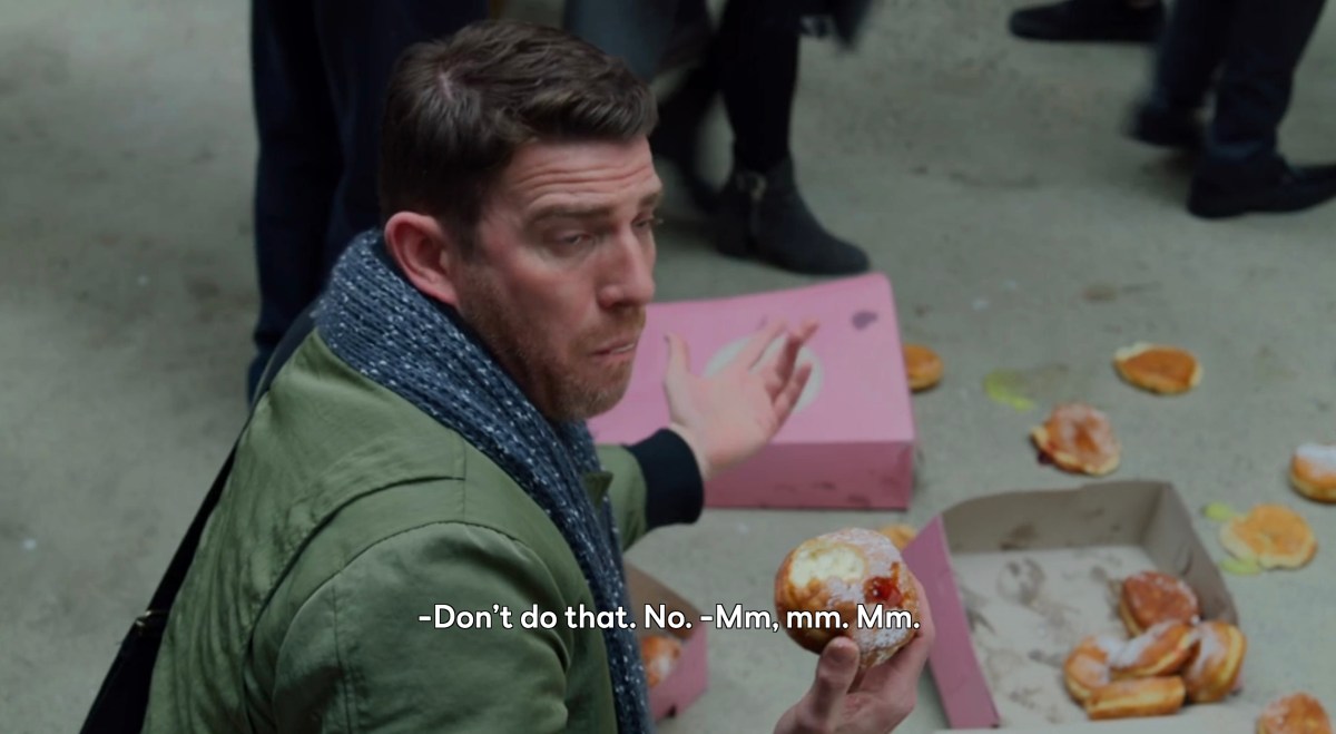 Round and Round: man eating donuts off the ground