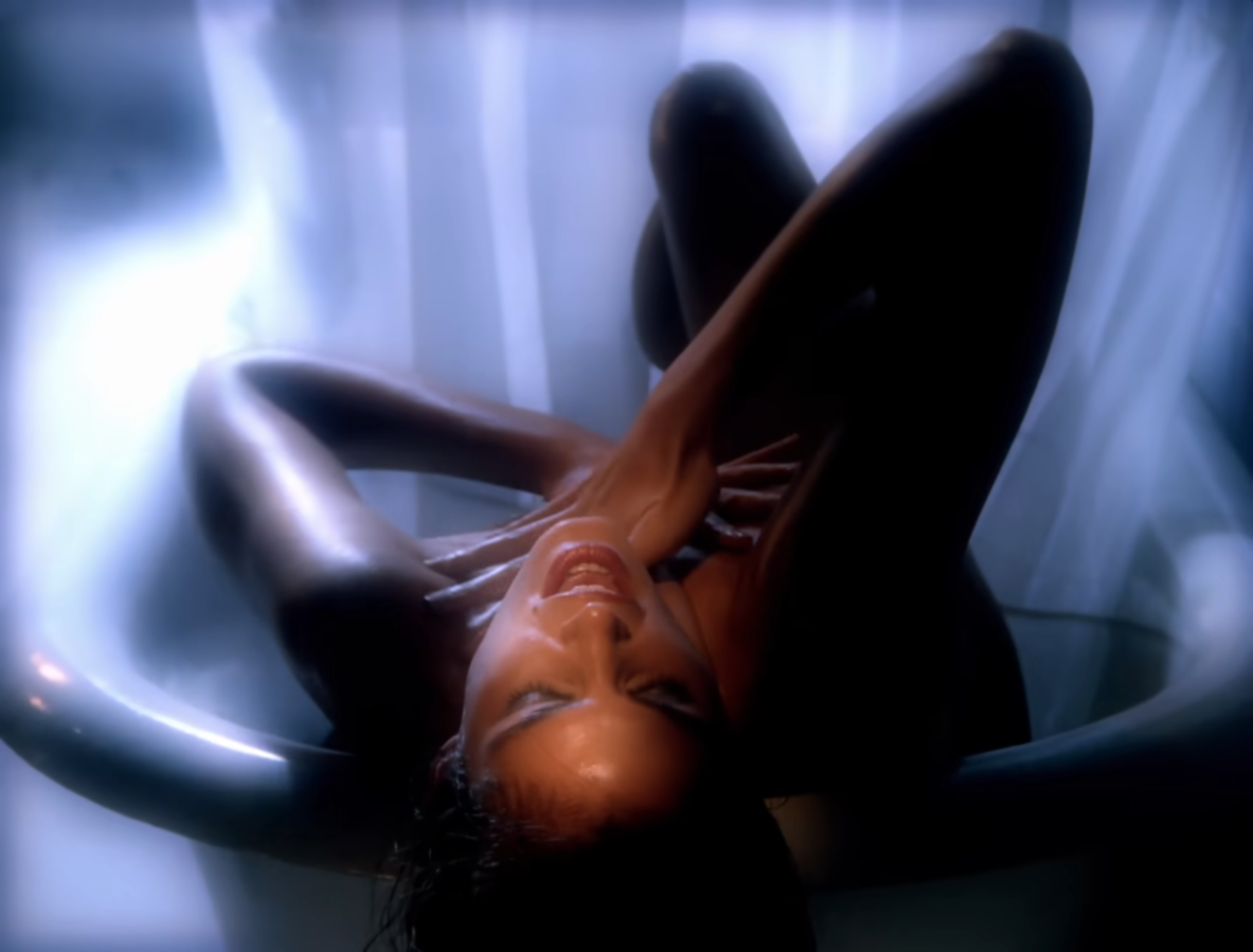 Cindy Crawford leans back in a bathtub