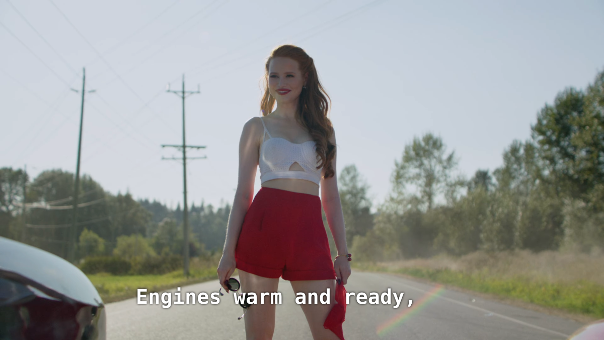 Cheryl stands between a street race. Cheryl: Engines warm and ready