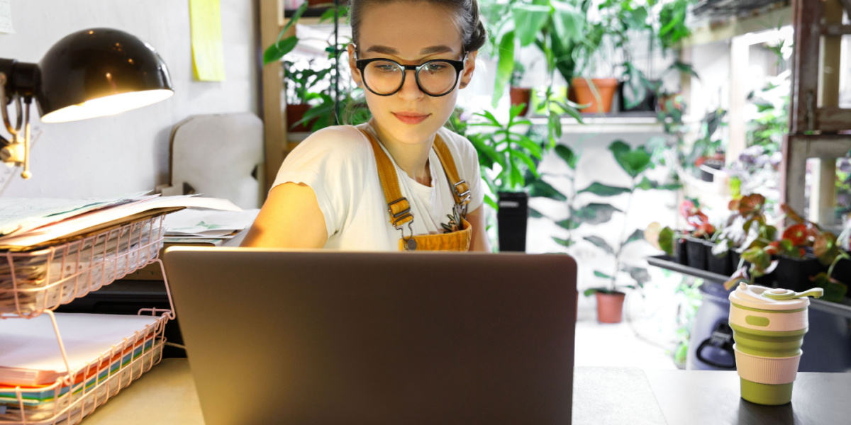 woman reading laptop in her apartment