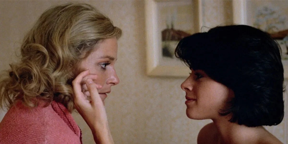 Two women in the 1980s embrace in Desert Hearts