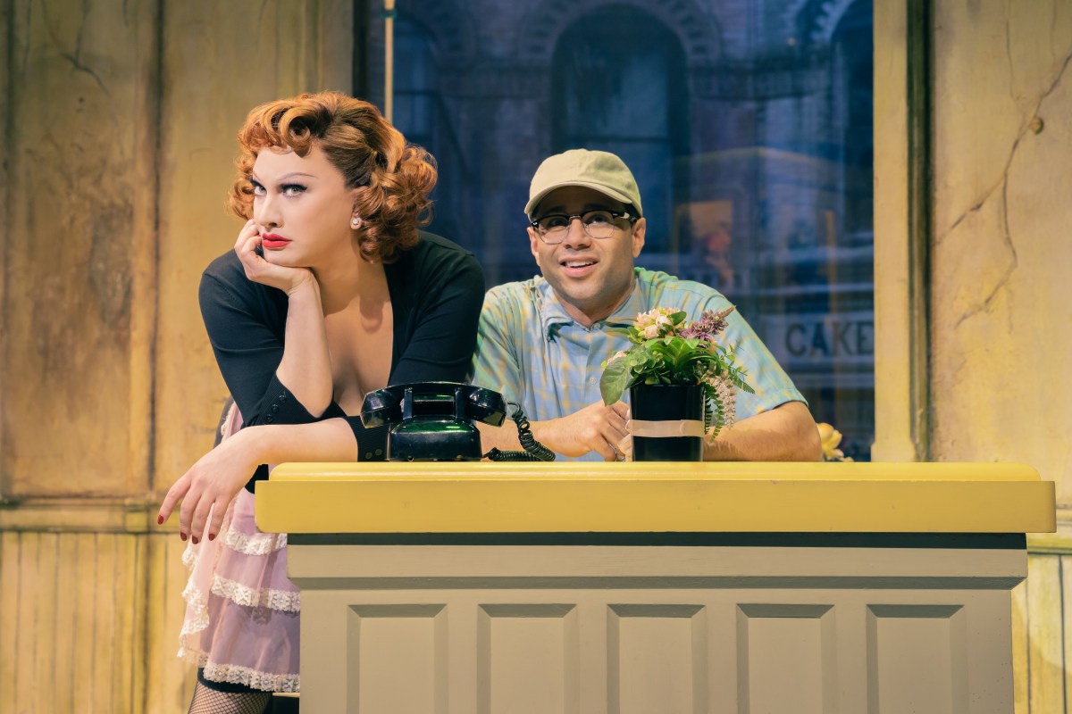 Jinkx Monsoon as Audrey rests her head in her hand next to Corbin Bleu as Seymour.