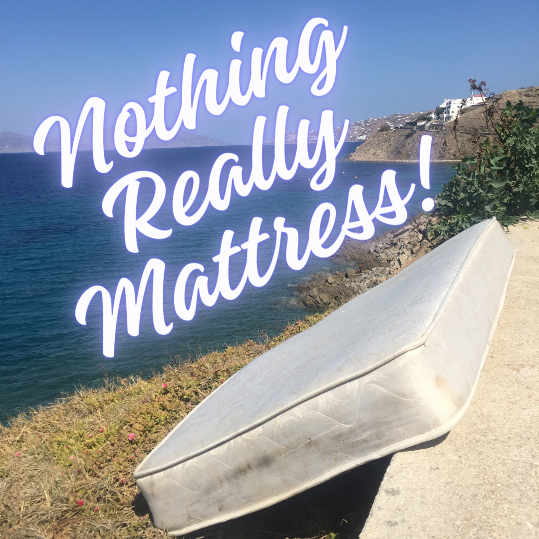 a photo of a mattress discarded by the ocean with bright cursive atop that reads "nothing really mattress"