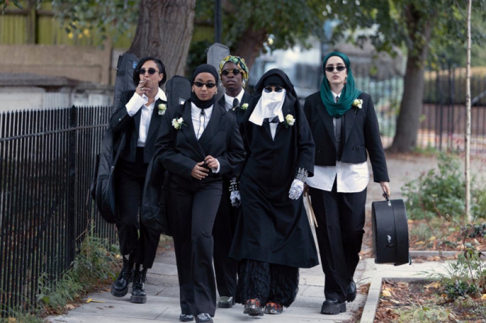 We Are Lady Parts season two: Dressed in all black suits with white shirts (and wearing black sunglasses), the members of Lady Parts make their way to a gig at a wedding.