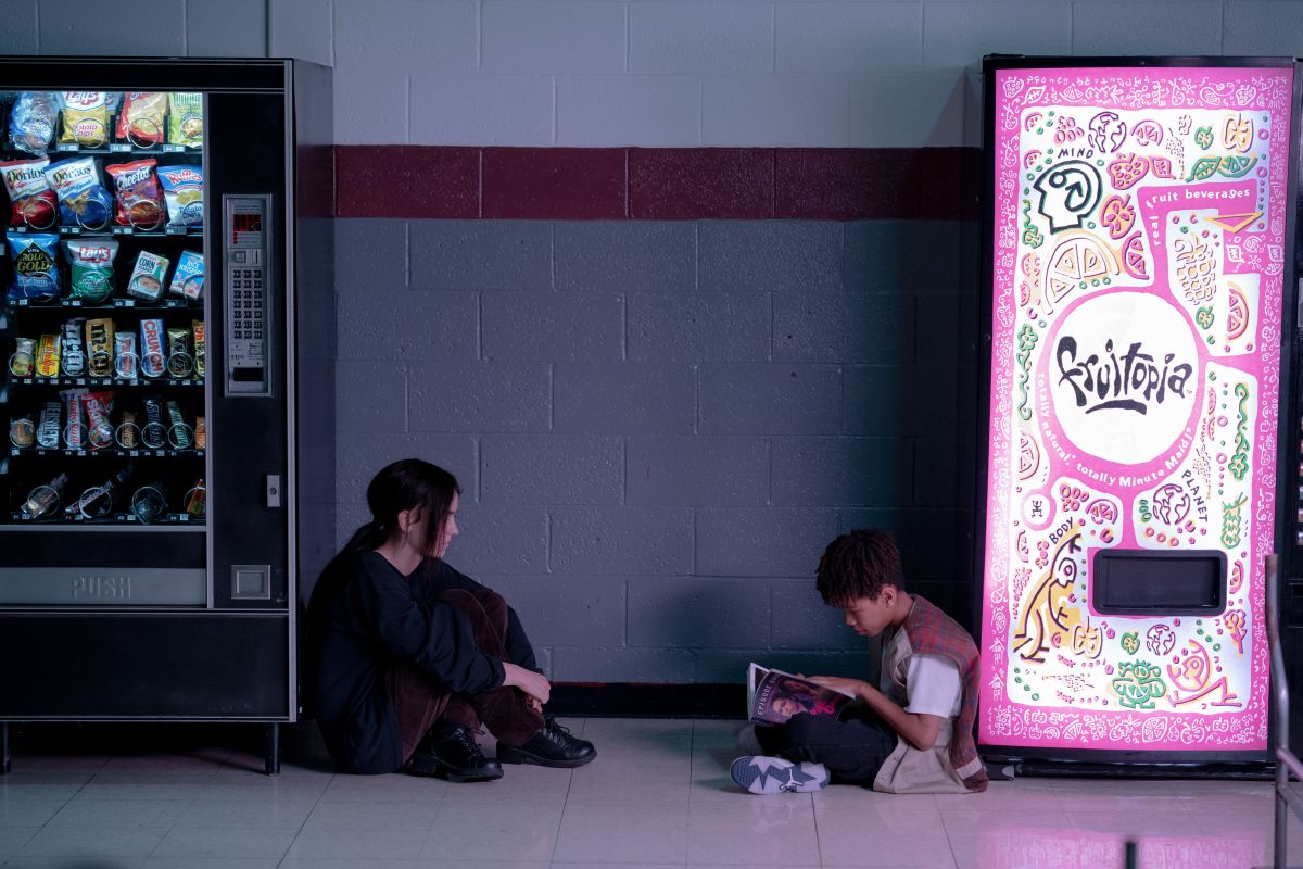 Jack Haven sits between two vending machines across from Ian Foreman