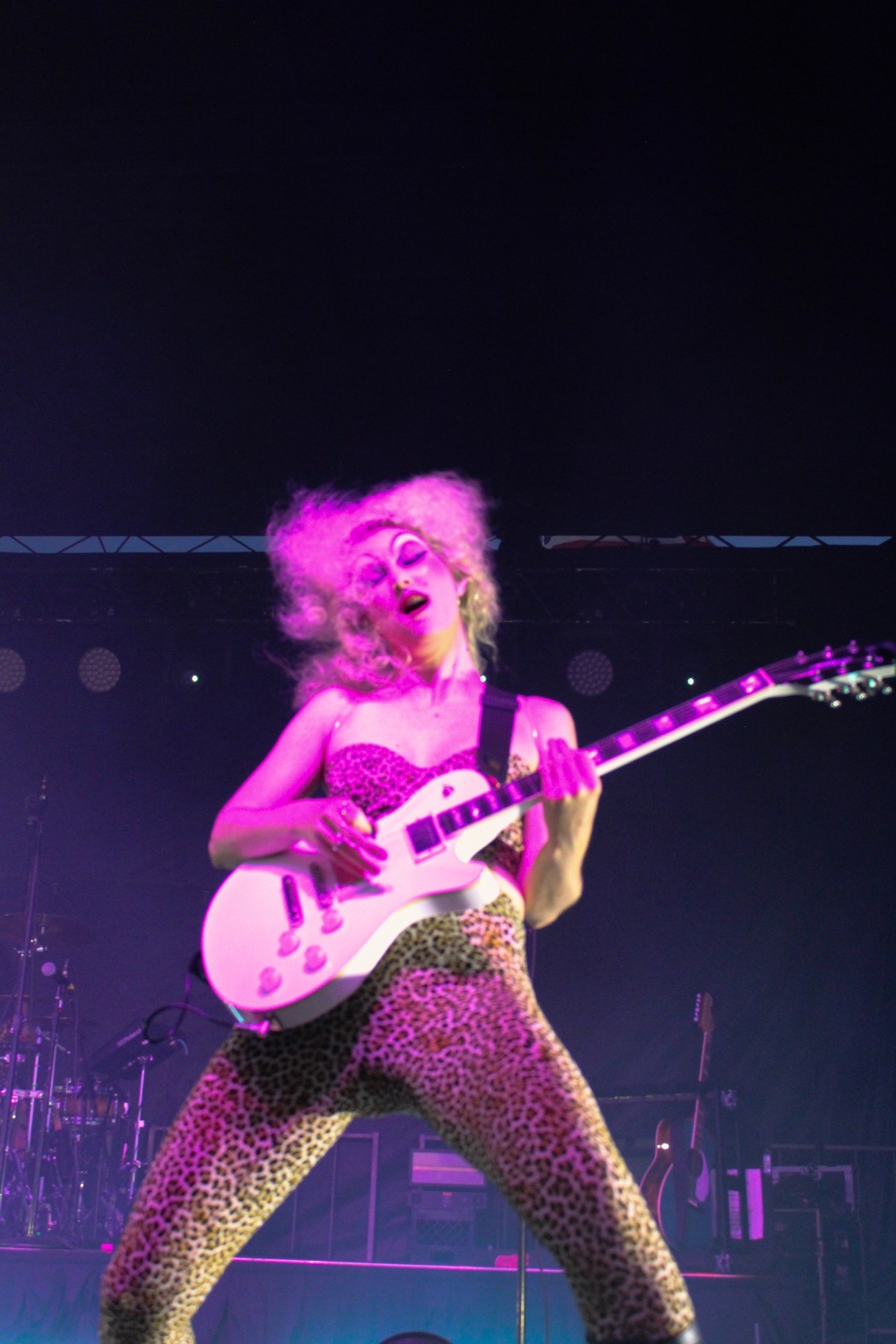 Chappel Roan with a guitar and a leopard onepiece