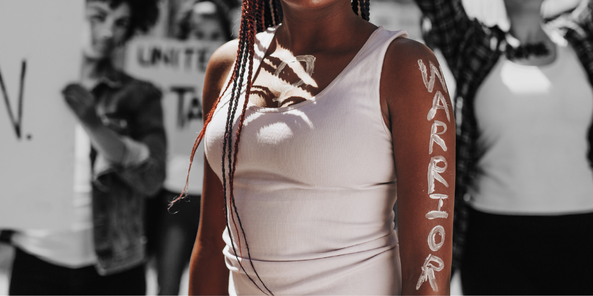 a person with WARRIOR written on their arm