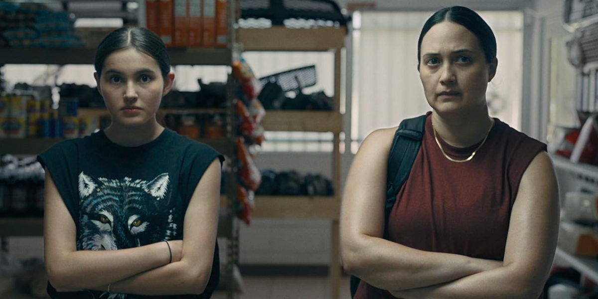 Lily Gladstone and Isabel Deroy-Olson sit side by side with their arms crossed.