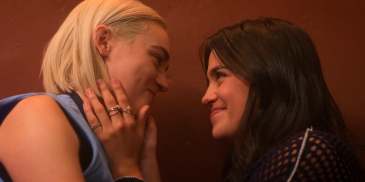 noa and jenny smiling at each other face to face