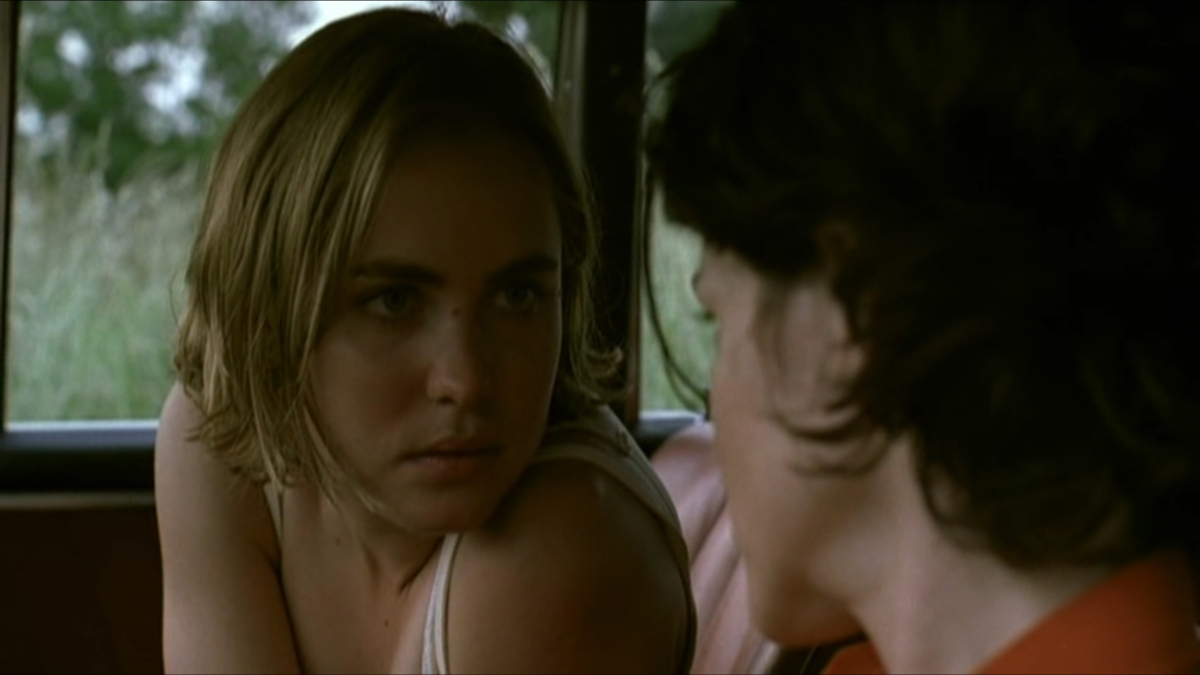 Radha Mitchell looks at Ally Sheedy in a car.