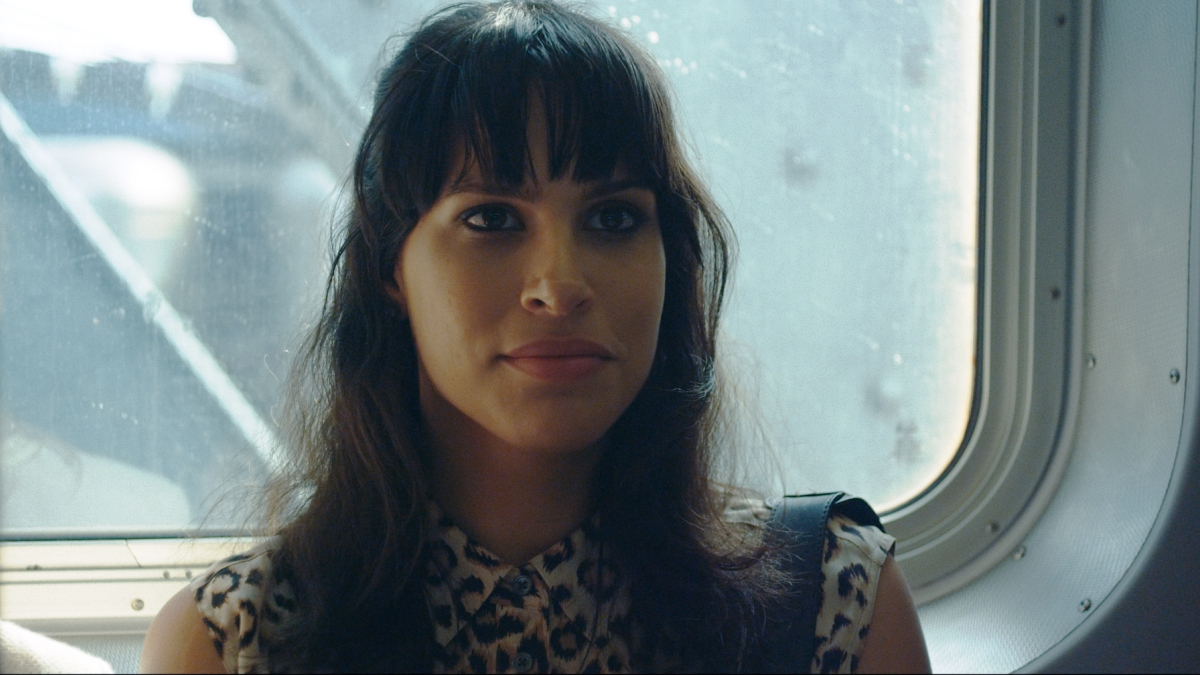 A close-up of Desiree Akhavan on the subway.