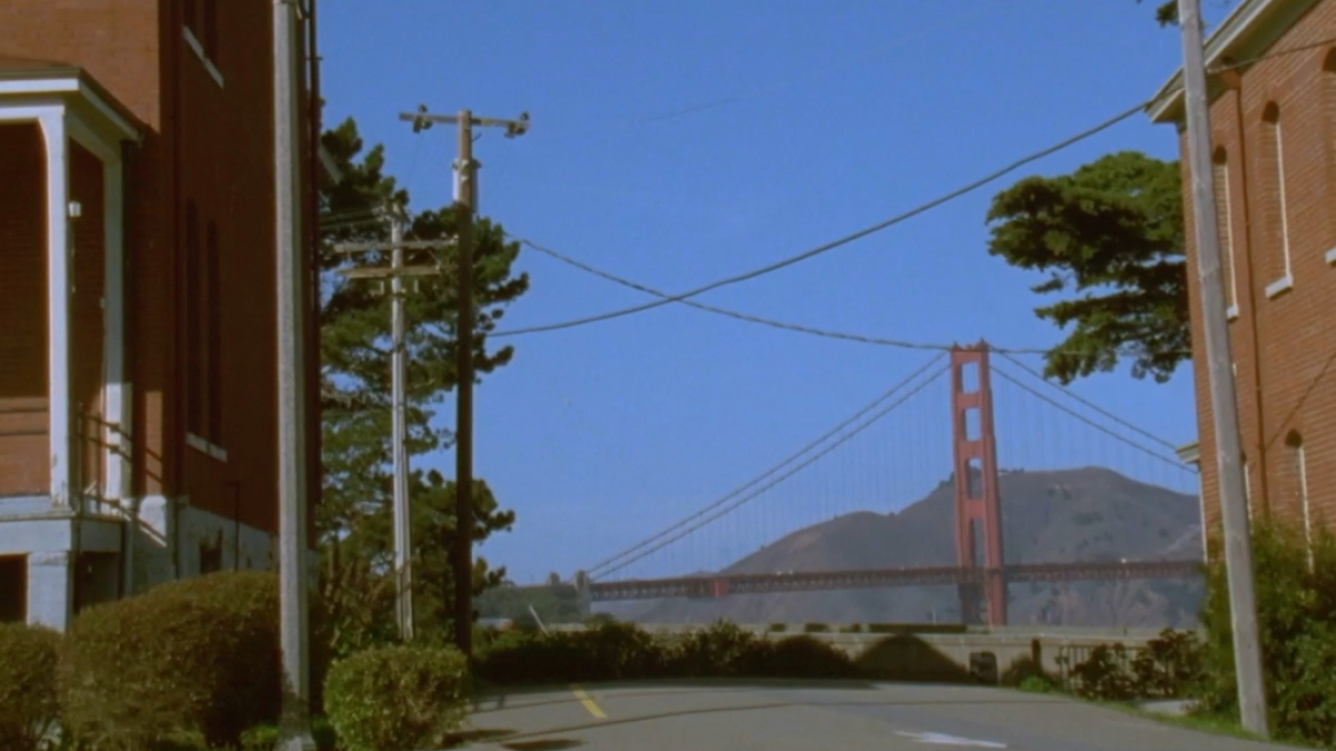 The Golden Gate Bridge framed by two buildings.