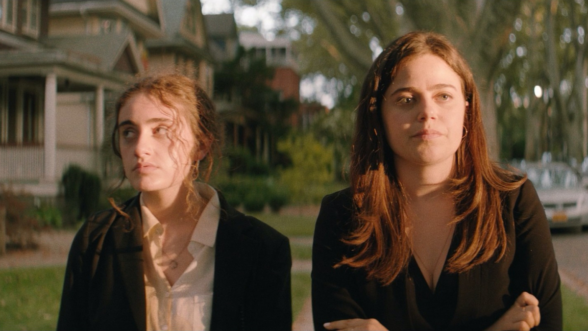 Best lesbian movies #50: Rachel Sennott and Molly Gordon walk on a suburban street.