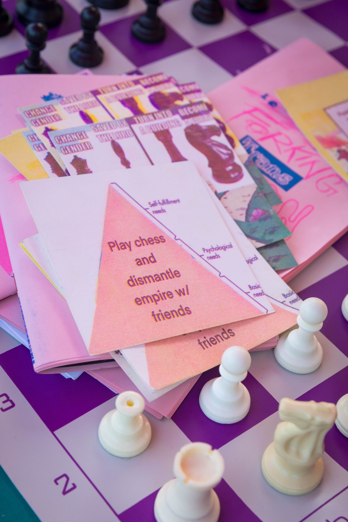 a zine that says PLAY CHESS AND DISMANTLE EMPIRE WITH FRIENDS