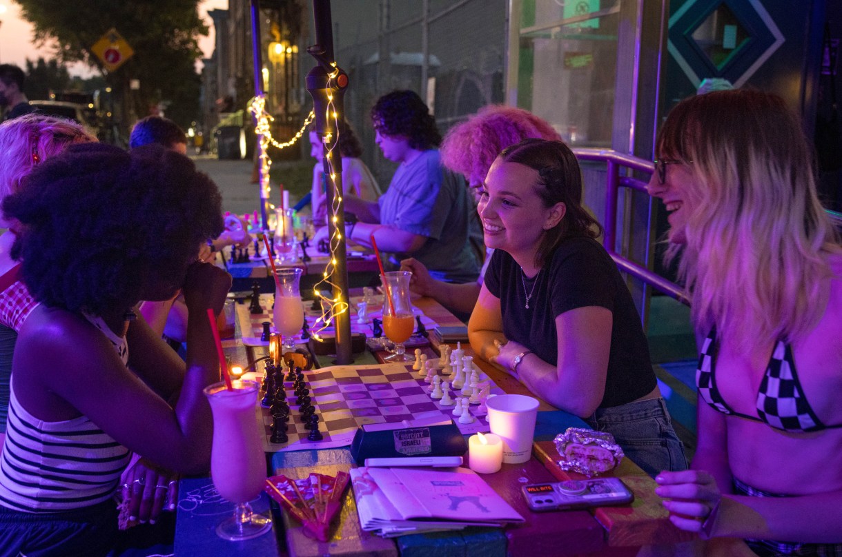 the author Audrey Black playing chess with a group