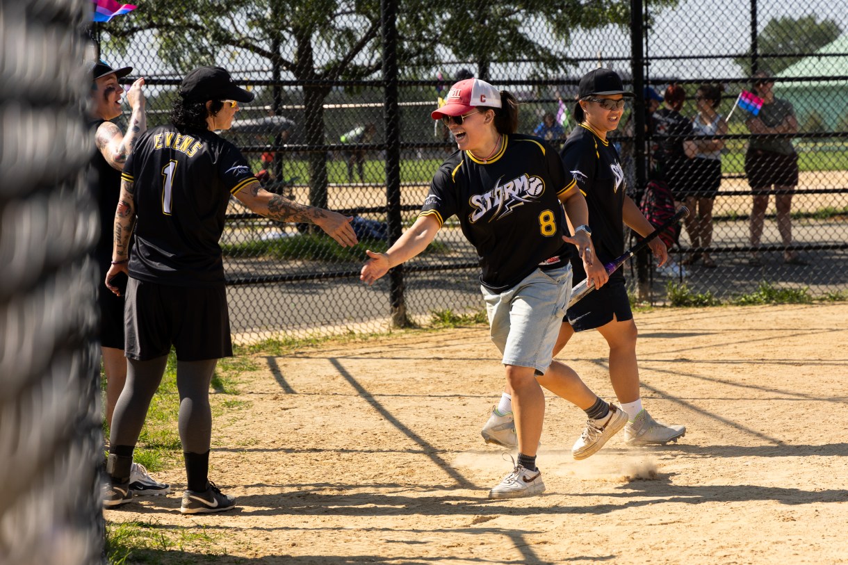 two softball players high five