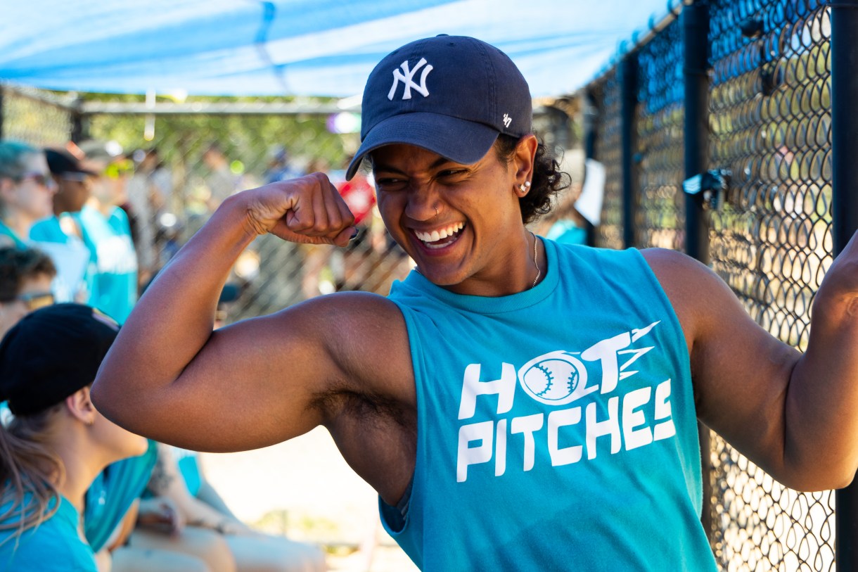 a member of Hot Pitches flashes their muscle