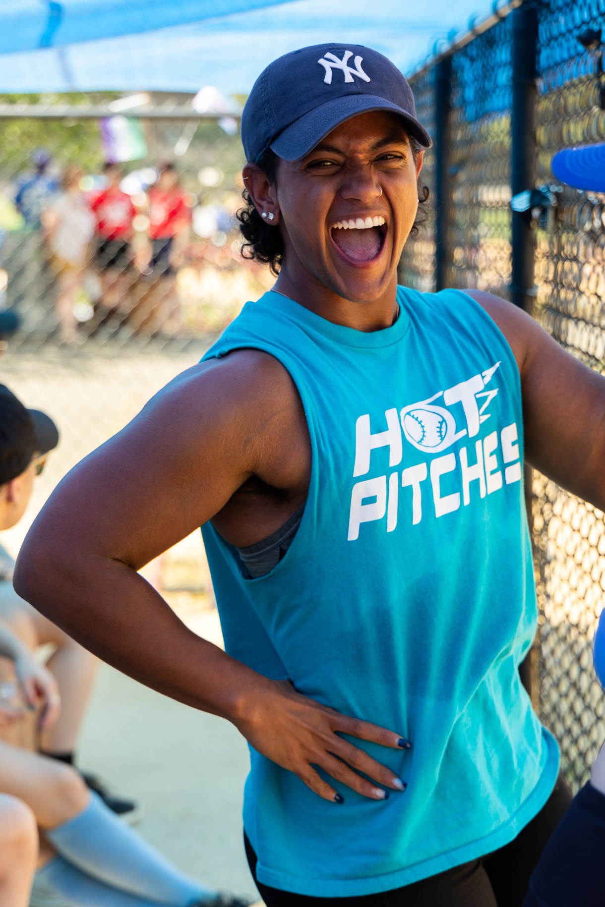 a person smiles big in a HOT PITCHES jersey