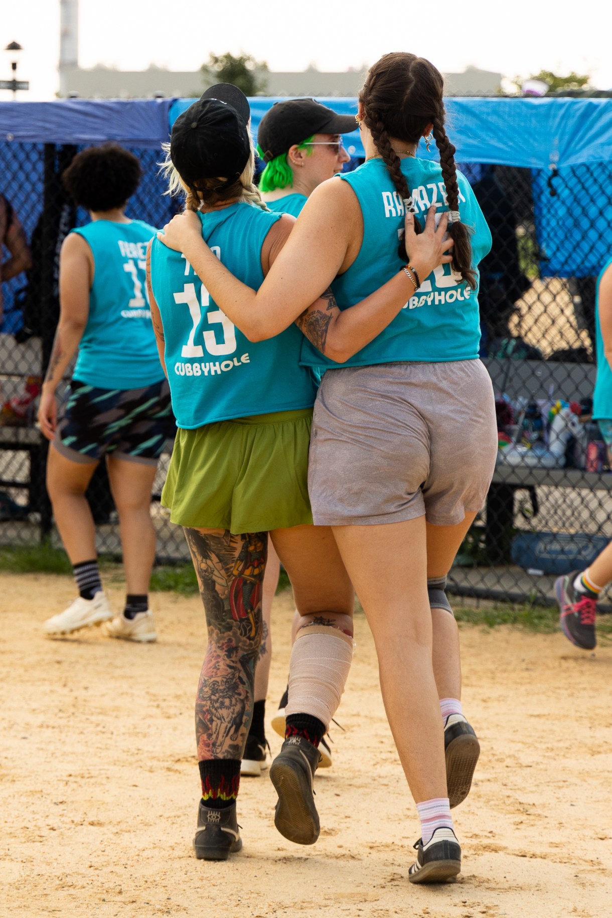 two softball players embrace